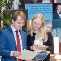 Attendees reading the program.